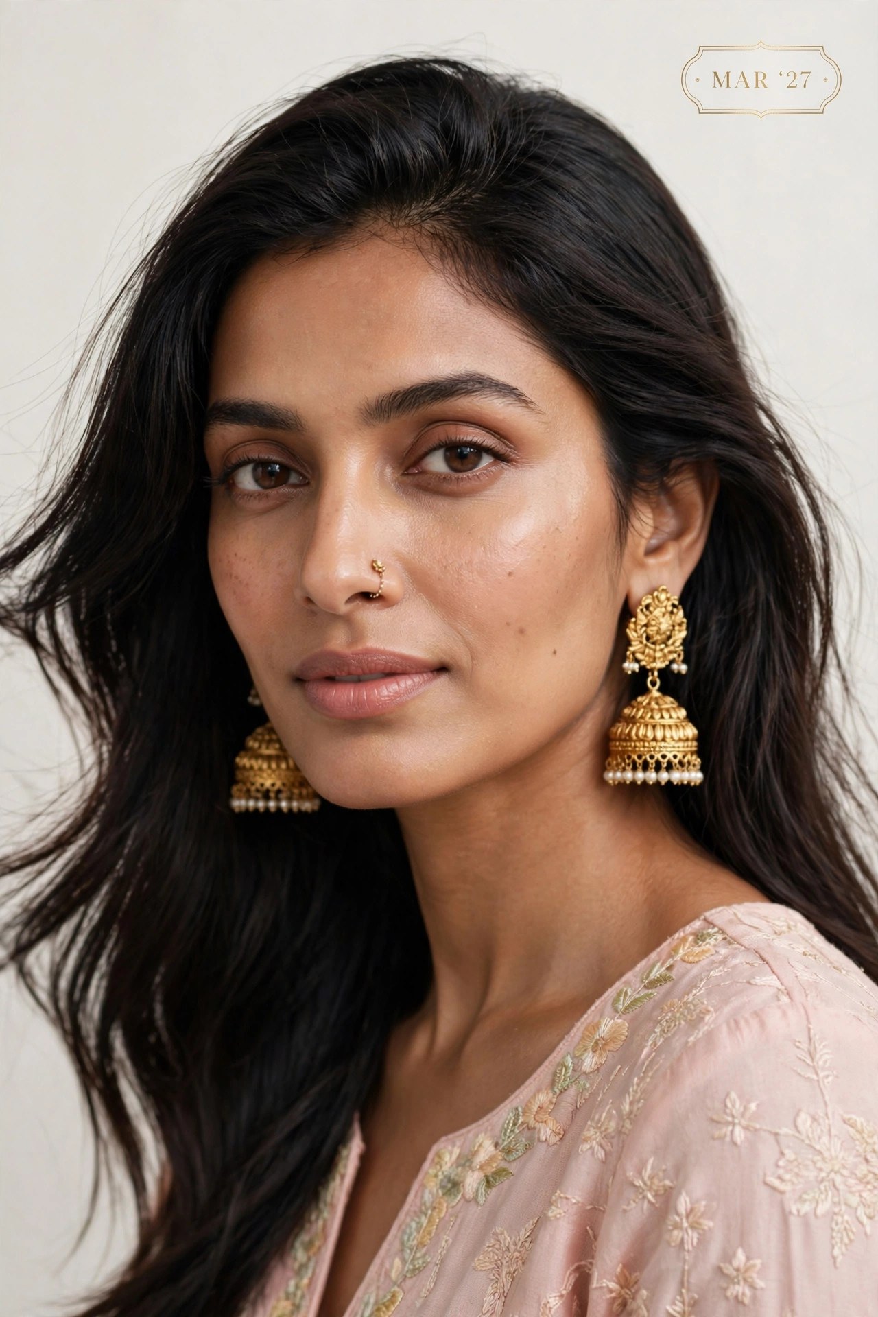 The Swag World Calendar 2027 March Spread - Model wearing intricate gold dome jhumkas with seed pearls and delicate nose ring